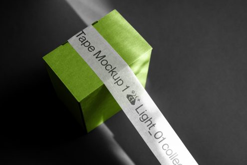 Green box with silver tape mockup on dark background, ideal for branding presentations and design assets.